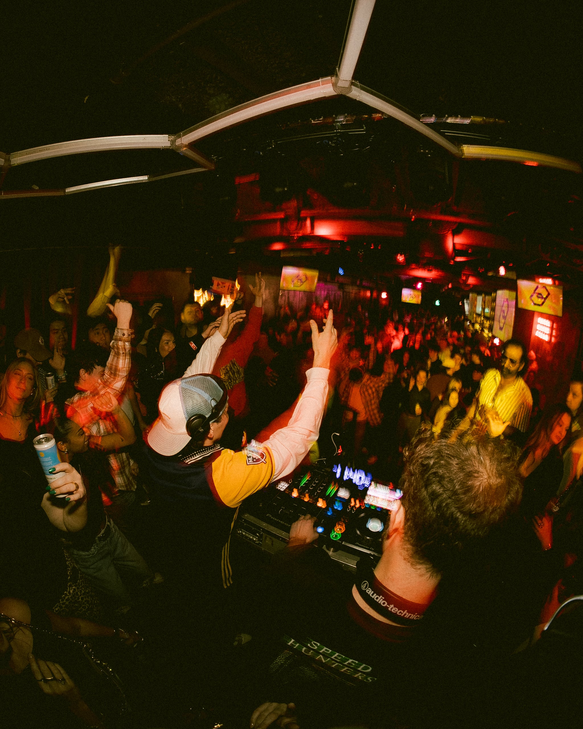 DJ performing at house music event with professional equipment